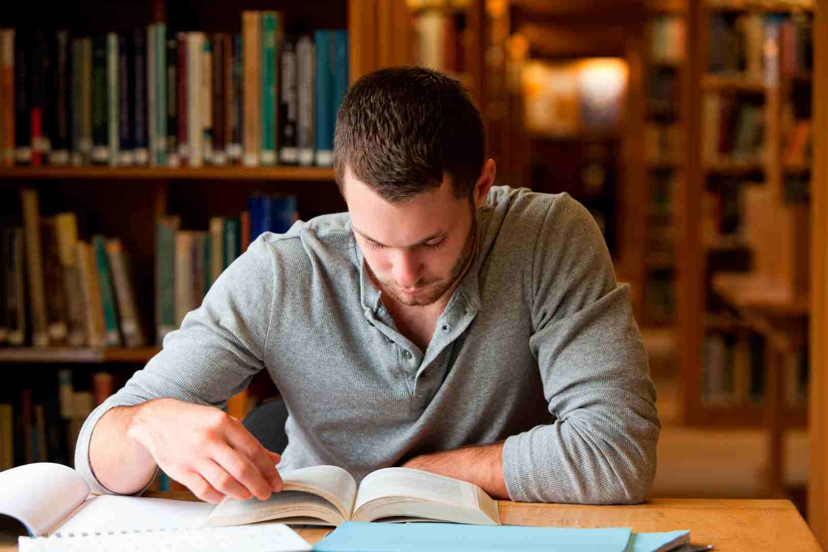 Man reading book in library