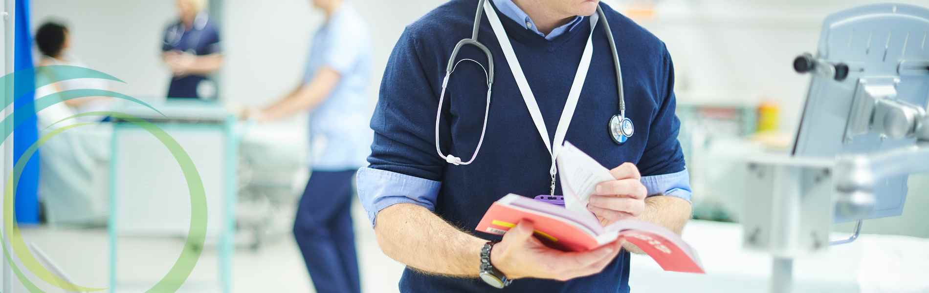 Doctor in clinical setting with a book